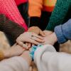 People putting hands together in a circle