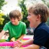Two boys play outside