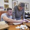 Professor works with student analyzing archives