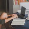 person typing on laptop