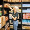 person stocking shelves with food