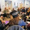 Diversity and Inclusion Summit attendees sit in a circle and talk.