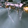 Image looking down at the legs of a spacecraft with gray rocks below