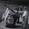 Ensign Mary F. Waters and Lt. Wm. J. Sweeny check a 20 mm canon at Bethlehem Hingham Shipyard in Massachusetts in 1944.