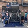 Mechanical engineering students with their scrap metal disposal device