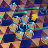 Graphic showing a material made up of octahedra with loop currents (arrows moving in a circle) flowing inside. Green dots representing electrons also whiz through.