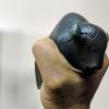 Person squeezes a Buff-shaped stress ball