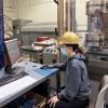 Graduate student conducts tests in lab