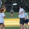 Students playing frisbee on campus