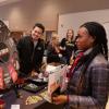 Student spins a prize wheel at The Connection booth at the spring Involvement Fair