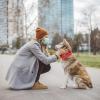 person in mask outside with dog