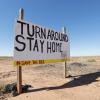 Navajo Nation sign that reads 'Turn around. Stay home'