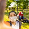 People wearing masks sitting outside