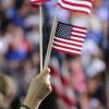 people waving small American flags