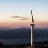 wind turbines with mountain range in background