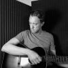 Jeff Widenhofer playing acoustic guitar