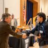 Student shakes hands with an employer at a campus career fair