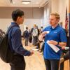 student speaking to an employer at a career fair
