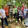 John Zhai (center) measures air quality with community members in Indonesia