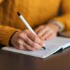 person writing in journal