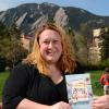Karstee Davis holding "Eat Pray Love" book in front of the Flatirons