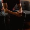 Person sitting on couch with hands folded on lap