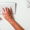 Woman types on keyboard