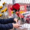 Mourners place flowers in a fence surrounding the King Soopers parking lot after a shooting in March 2021