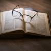 Old book with glasses on it