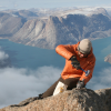 Researcher taking a sample atop a mountain