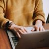 A person with a laptop in their lap.