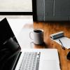 Laptop on table with a cup of coffee