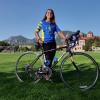 Lauren Gray and bike with Flatirons in the background