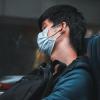Person listening to music on a train in Taiwan while wearing a face mask