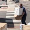A person loading PPE supplies into a truck