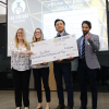 The Sick Stick team posing with a large check at the 2019 Lab Venture Challenge