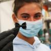 Whitney Knoop holding a 3D-printed plastic device used in water reclamation efforts