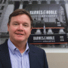 Michael Huseby stands in front of Barnes & Noble Education storefront