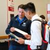 student speaking with someone at a career fair