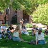 Students sitting in a circle outside