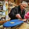 Mechanical engineering alumnus Mike Maloney works on KOTA longboard