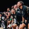 Members of the 2023 Buff Women’s Basketball Team cheer from the sideline