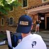 Volunteer wearing Fall Welcome Squad hat