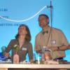 Two faculty members present an electrical light-based experiment.