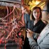 Henry Kapteyn and Margaret Murnane talk to graduate student Qing Li in their lab at JILA