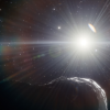 asteroid covered in shadows with sun in the background