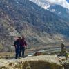 Men standing next to a mountain range.