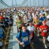 Thousands of people run across a bridge
