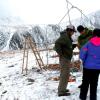 Three research collect data on a snowy Niwot Ridge.