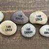 Image of rocks displaying messages of self-affirmation.